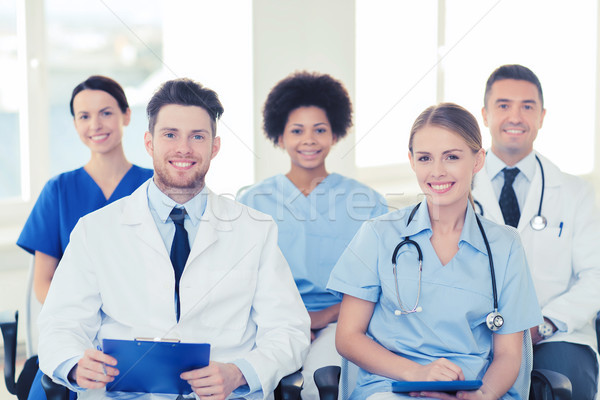 group of happy doctors on seminar at hospital Stock photo © dolgachov