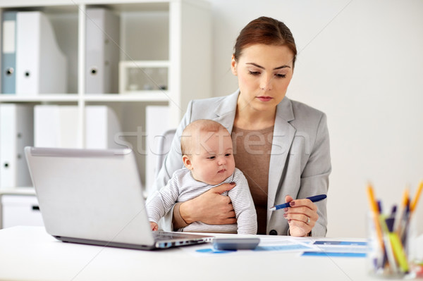 happy businesswoman with baby and laptop at office Stock photo © dolgachov