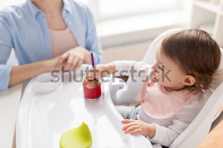mother feeding baby with puree at home Stock photo © dolgachov