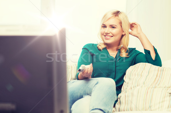 Mujer sonriente remoto viendo tv casa televisión Foto stock © dolgachov