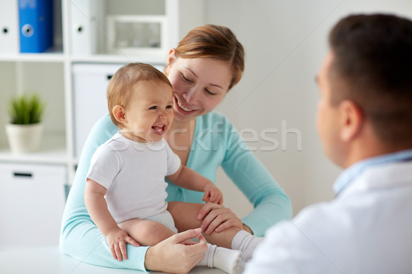 happy woman with baby and doctor at clinic Stock photo © dolgachov
