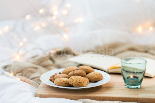 oatmeal cookies and candle in holder at home Stock photo © dolgachov
