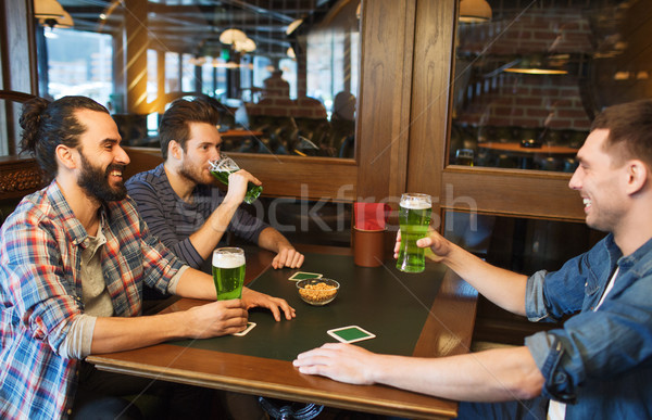 male friends drinking green beer at bar or pub Stock photo © dolgachov
