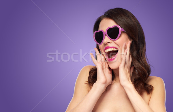 woman with heart shaped shades over ultra violet Stock photo © dolgachov