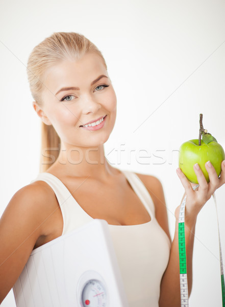 sporty woman with scale, apple and measuring tape Stock photo © dolgachov