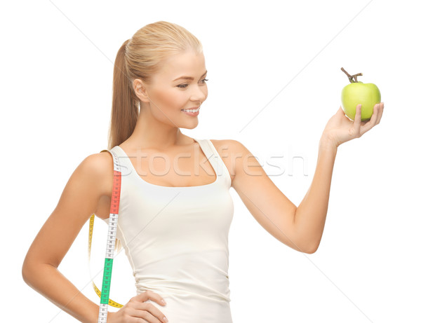 Stock photo: sporty woman with apple and measuring tape