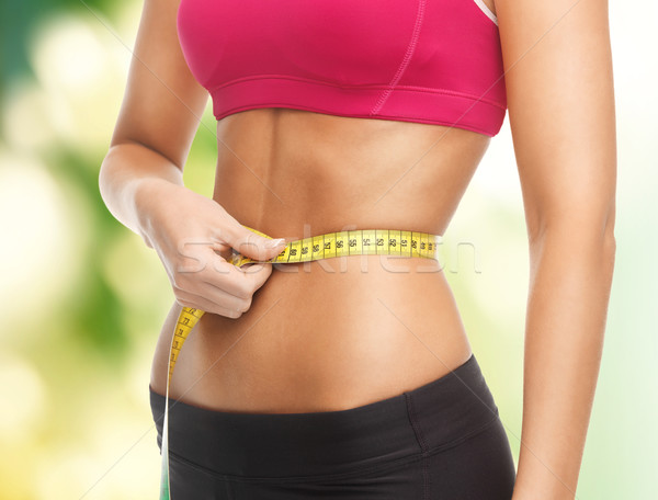 trained belly with measuring tape Stock photo © dolgachov