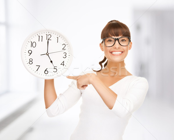 businesswoman with wall clock Stock photo © dolgachov