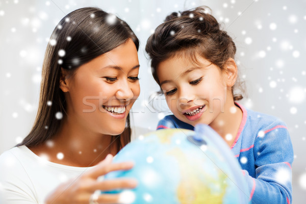 mother and daughter with globe Stock photo © dolgachov