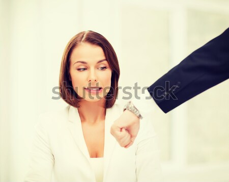 boss showing time to stressed businesswoman Stock photo © dolgachov