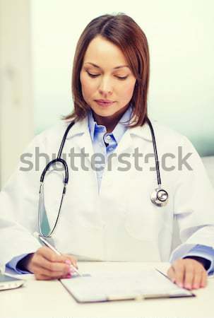 female doctor or nurse measuring blood sugar value Stock photo © dolgachov
