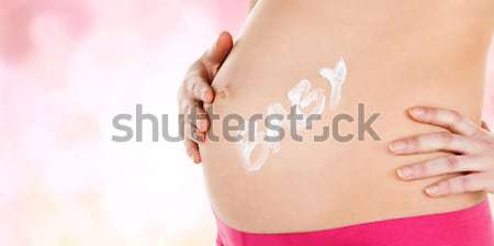 belly of a pregnant woman Stock photo © dolgachov