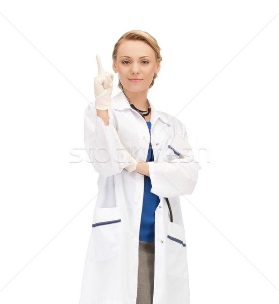 Sorridere femminile medico punta dito up Foto d'archivio © dolgachov