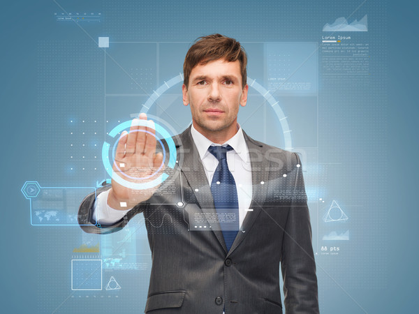 attractive buisnessman wotking with virtual screen Stock photo © dolgachov