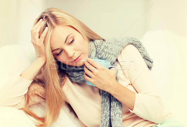 diseased woman with cup of tea Stock photo © dolgachov