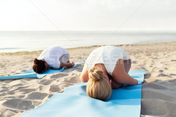 close up of couple making yoga exercises outdoors Stock photo © dolgachov