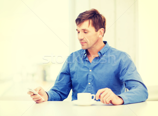 buisnessman with smartphone and cup of coffee Stock photo © dolgachov