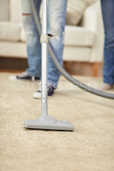 close up of human legs and vacuum cleaner at home Stock photo © dolgachov