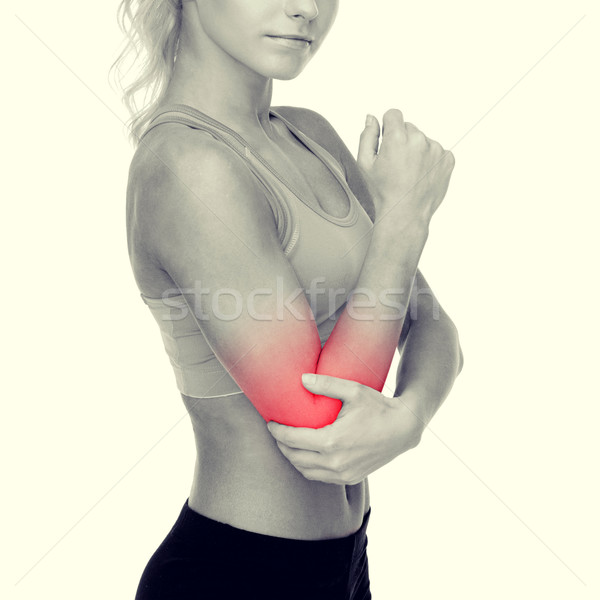 sporty woman with pain in elbow Stock photo © dolgachov