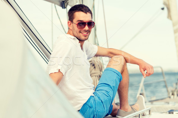 man sitting on yacht deck Stock photo © dolgachov