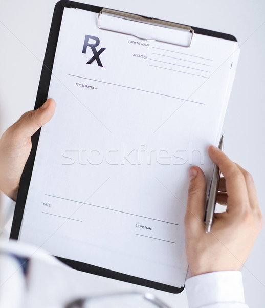 male doctor writing prescription paper Stock photo © dolgachov