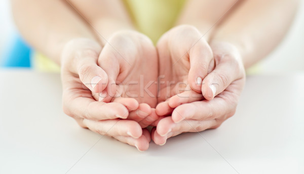 close up of woman and girl with cupped hands Stock photo © dolgachov