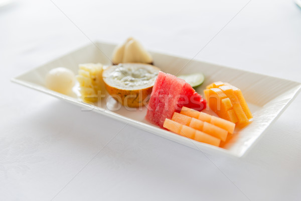 plate of fresh juicy fruit dessert at restaurant Stock photo © dolgachov