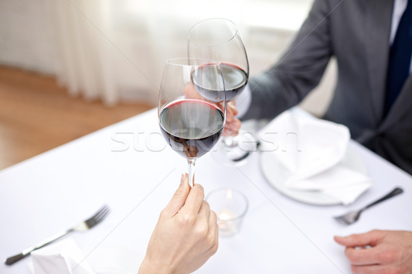 young couple with glasses of wine at restaurant Stock photo © dolgachov