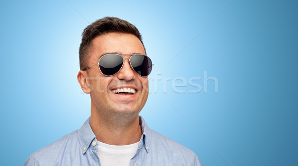 face of smiling man in shirt and sunglasses Stock photo © dolgachov