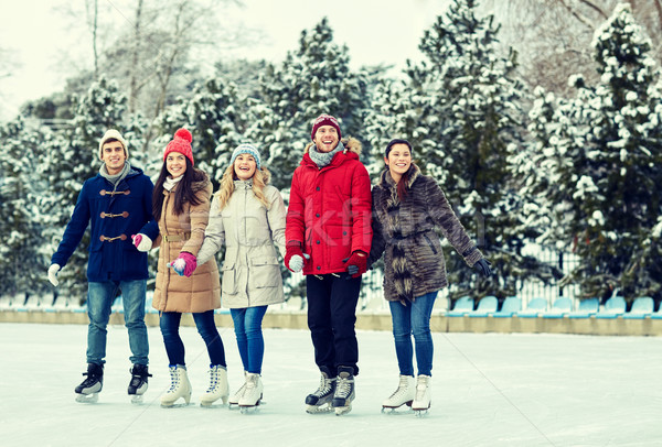 happy friends ice skating on rink outdoors Stock photo © dolgachov