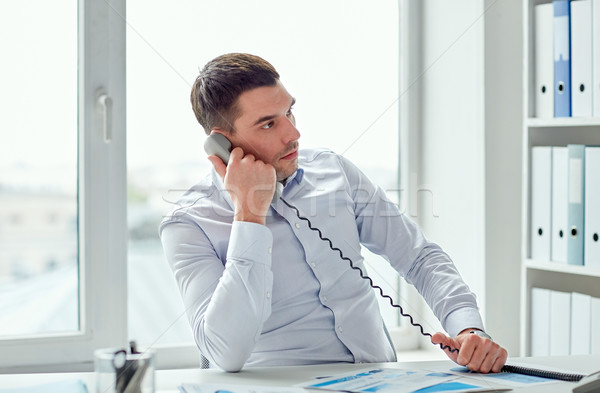 angry businessman calling on phone in office Stock photo © dolgachov