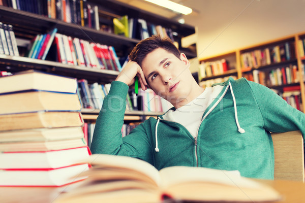 Unatkozik diák fiatalember könyvek könyvtár emberek Stock fotó © dolgachov