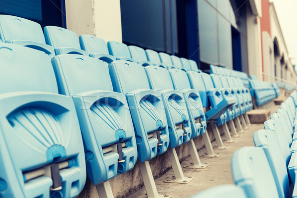 rows with folded seats of bleachers on stadium Stock photo © dolgachov
