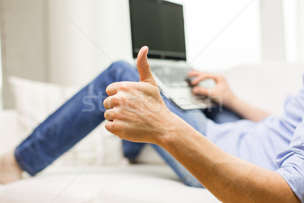 close up of man typing on laptop at home Stock photo © dolgachov