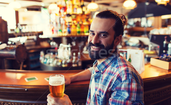 happy man drinking beer at bar or pub Stock photo © dolgachov