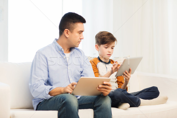 father and son with tablet pc at home Stock photo © dolgachov