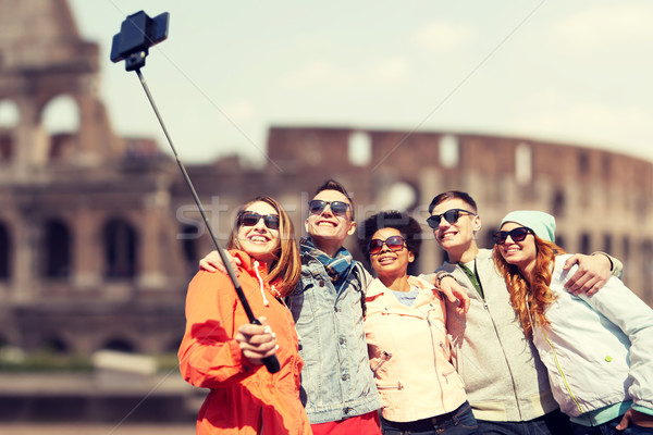 happy friends with smartphone selfie stick Stock photo © dolgachov
