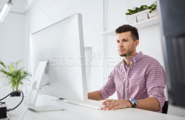 creative man or student with computer at office Stock photo © dolgachov