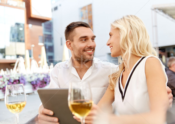 happy couple with tablet pc at restaurant terrace Stock photo © dolgachov