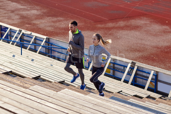 couple running upstairs on stadium Stock photo © dolgachov