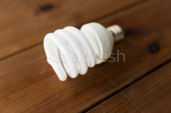 close up of energy saving lighting bulb on wood Stock photo © dolgachov