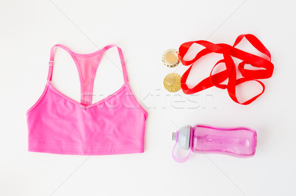 close up of sports top, golden medals and bottle Stock photo © dolgachov