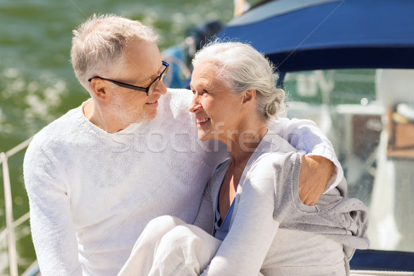 senior couple hugging on sail boat or yacht in sea Stock photo © dolgachov