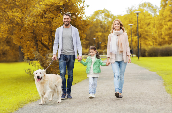 happy family with labrador retriever dog in park Stock photo © dolgachov