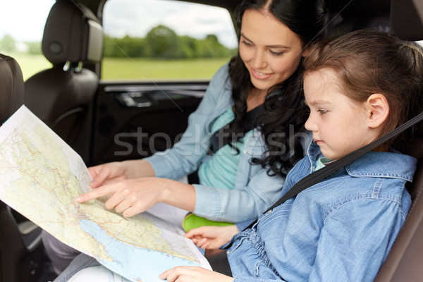 happy family with travel map driving in car Stock photo © dolgachov
