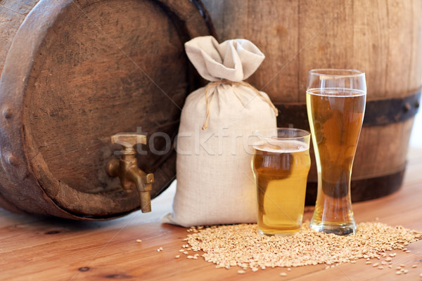 Stock photo: close up of beer barrel, glasses and bag with malt