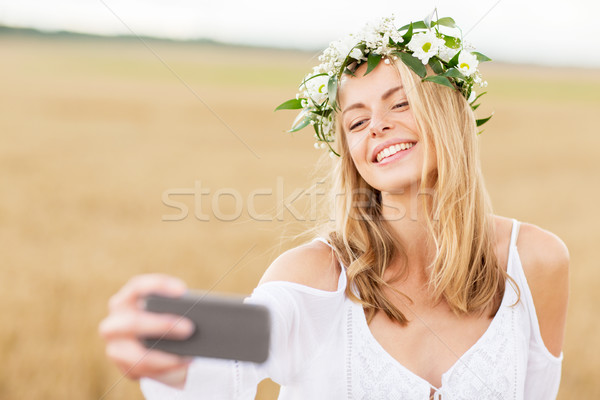 Stock photo: happy young woman taking selfie by smartphone