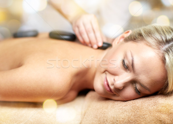 close up of woman having hot stone massage in spa Stock photo © dolgachov