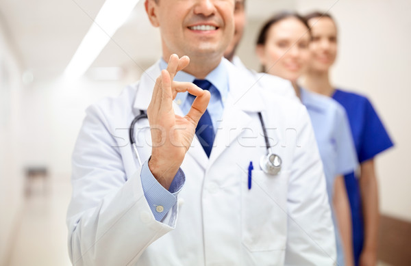 close up of doctors at hospital showing ok sign Stock photo © dolgachov