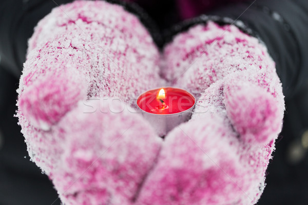 close up of hands in winter mittens holding candle Stock photo © dolgachov